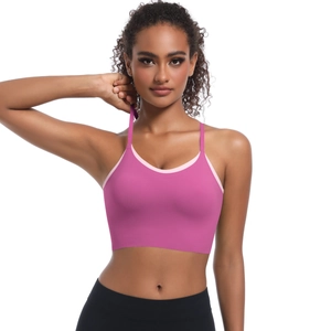 Close-up of rose pink sports bra with cross straps and contrast piping on the neckline