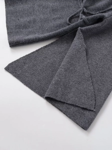 Detailed close-up of dark grey knit texture with ribbed edges and adjustable drawstring