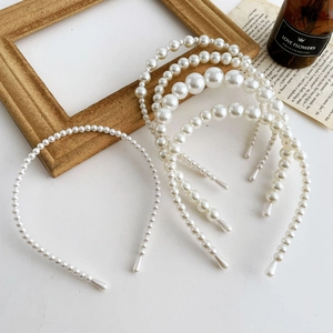 Vintage faux pearl headband set with gradient beads on minimalist white marble background