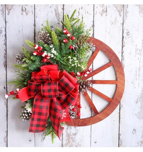 Close-up of wooden wheel Christmas wreath with buffalo plaid bow and pine cones