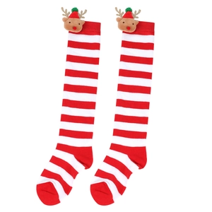 Detail of red and white striped Christmas stockings featuring plush reindeer with green hats