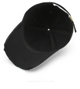 Detailed interior of a distressed black baseball cap with seams and metal buckle