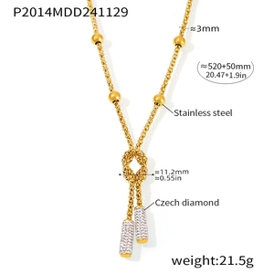 Detailed view of gold stainless steel necklace with knotted design and cubic zirconia pendants