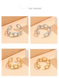 Detail view of adjustable chain-link rings in gold and silver finishes on beige blocks