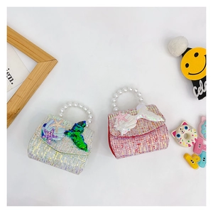 Detail of tweed girls' handbag with sequin mermaid tail, starfish, and pearl handle