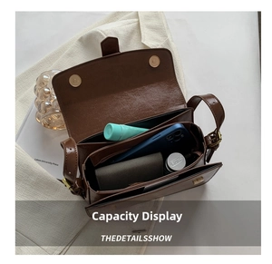 Internal storage layout of vintage brown leather bag with multi-layer compartments