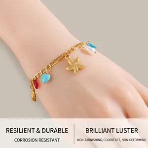 Detail of gold starfish and shell charms with colored beads on a Figaro chain bracelet