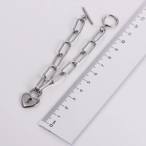 Silver OT clasp chain bracelet with heart lock charm and centimeter ruler for size scaling