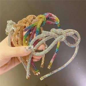 Close-up of sparkling rhinestone bow headbands in silver, gold, and colorful finishes