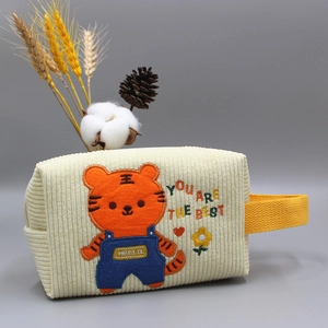 Beigefarbene Cord-Kosmetiktasche mit Tiger-Stickerei und gelbem Griff für Reise