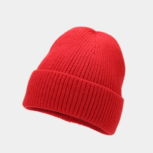 Detail of red ribbed knit beanie featuring thick texture and classic fold-over cuff design