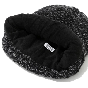 Detailed macro view of 100% acrylic knit hat with thick black fleece lining for warmth