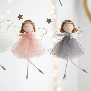 Close-up of pink and white plush Christmas angel ornaments with glittery mesh skirts