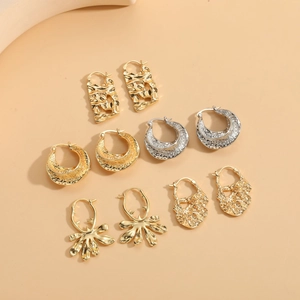 Macro view showing various textured gold and silver irregular geometric earrings