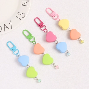 Set of four colorful heart chain keychains with pastel beads on a white surface