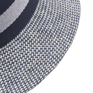 Macro shot of fine tricolor weave on a vintage straw hat brim in navy and beige
