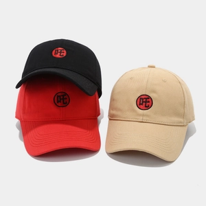 Detailed embroidery of character on black, red, and beige cotton twill baseball caps