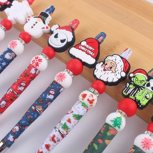 Christmas themed beaded ballpoint pens with Santa Claus and cartoon character silicone toppers