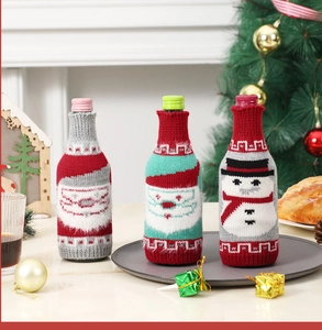 Three festive Christmas knit wine bottle covers featuring Santa and snowman patterns