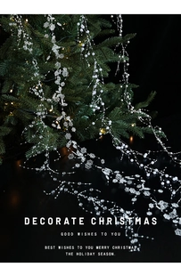 Close-up of white pearls and crystal snowflake garland strands on a Christmas tree
