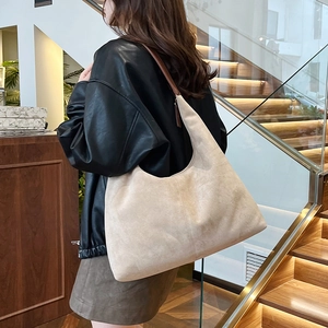 Minimalist beige large capacity tote bag in matte suede shown on model in modern interior