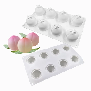 Detail of 8-cavity white silicone mold showing 3D peach fruit shape for mousse cake baking