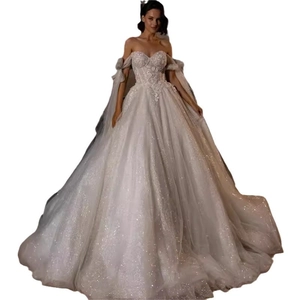 Elegant white off-the-shoulder ballgown wedding dress with lace floral appliqués and sequins