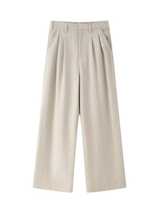 Detail view of high-waist beige wide-leg trousers featuring double pleats and sleek belt loops