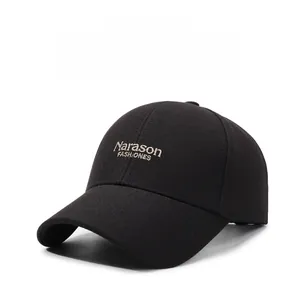 Detailed close-up of golden Narason FASHIONS embroidery on a black cotton baseball cap
