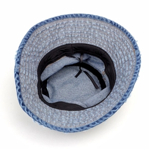 Detailed view of frayed edges on a washed blue denim bucket hat with adjustable inner strap