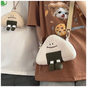 Detail of plush rice ball crossbody bag and coin purse with embroidery and adjustable strap