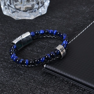 Close-up of men's leather stone bracelet with personalized name engraving on steel bead