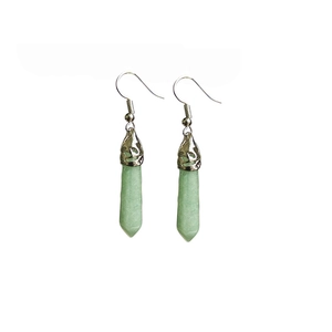 Detail of silver drop earrings with hexagonal light green natural stone pendants