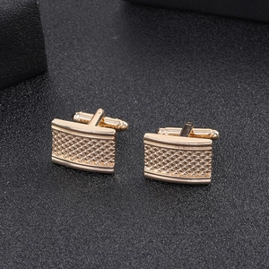 Men's gold square cufflinks with textured grid pattern for formal business suits