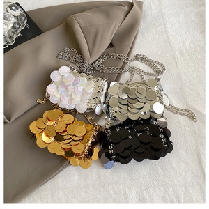 Flat lay of mini sequin crossbody bags in white, silver, gold and black with chain straps