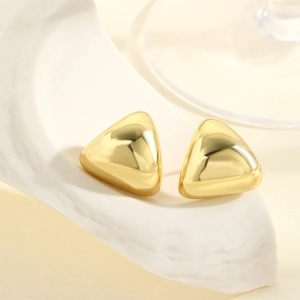 Elegant gold polished geometric triangle stud earrings on white stone display base