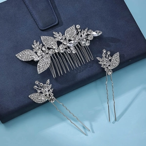Close-up of bridal hair comb set with sparkling rhinestones and crystal leaf patterns