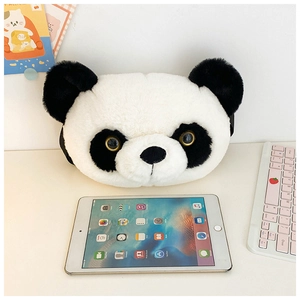 Detailed close-up of a plush panda head bag on a desk next to a white keyboard