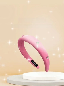 Detail of pink sponge headband featuring heart rhinestones and handmade inner label