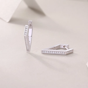 Detail view of silver triangle hoop earrings featuring elegant double row cubic zirconia