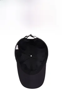 Internal view of black sun hat showing breathable seams and adjustable buckle strap