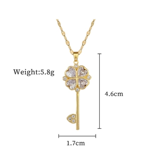 Detail view of gold flower key necklace pendant with weight and size dimensions