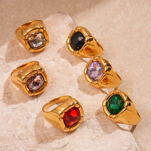 Detailed view of six vintage gold-tone rings with colorful square zircons on stone