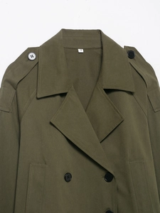Detail of army green double-breasted trench coat showing epaulettes and collar textures