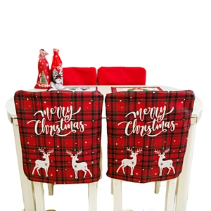 Red plaid Christmas chair covers featuring Merry Christmas text and reindeer prints