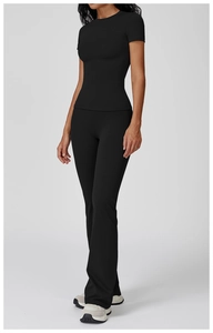 Slim fit black yoga set featuring crew neck short sleeve top and flared leggings
