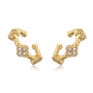 Detail of gold clover ear cuffs featuring sparkling crystals and a minimalist open design