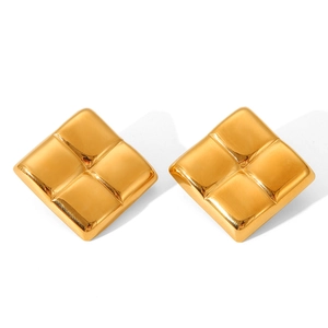 Macro shot of gold-plated square stud earrings featuring a textured geometric pattern