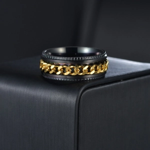 Detail of black matte stainless steel ring with golden Cuban chain inlay for men