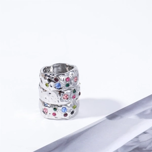 Stacked silver rings with irregular crinkle texture and colorful zircon gemstone accents
